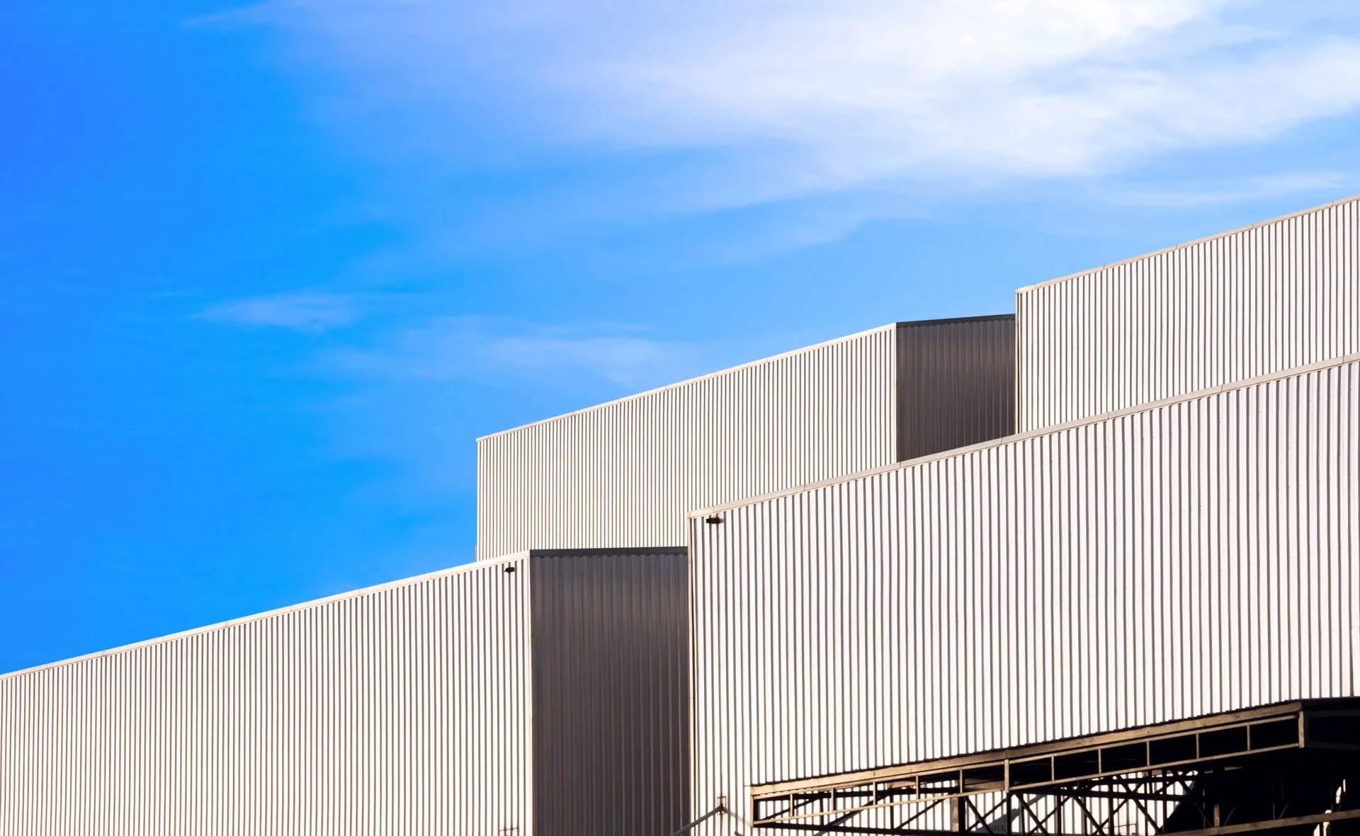 Group of industrial factory buildings with aluminium corrugated cladding