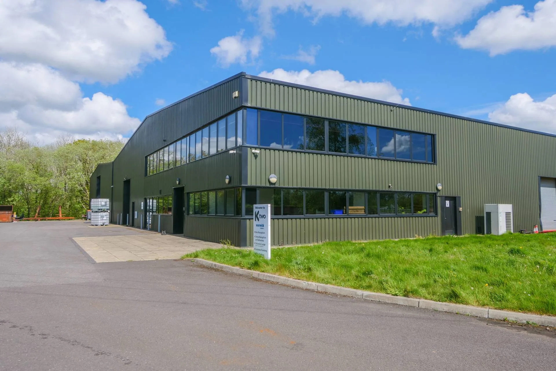 Modern industrial unit with green metal cladding and offices
