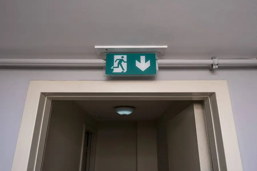 Green emergency exit sign above a doorway