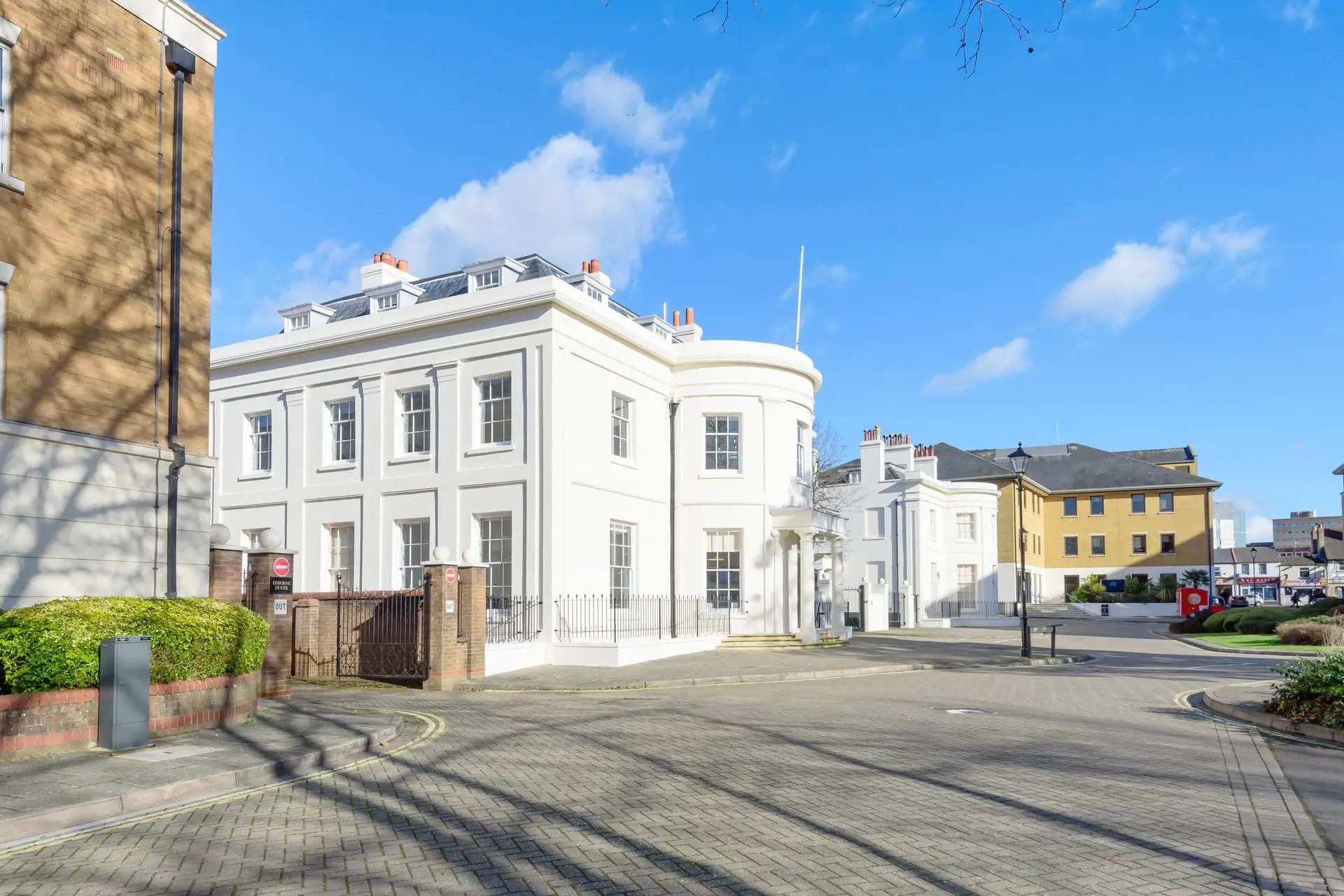 White Georgian-style building on a sunny street
