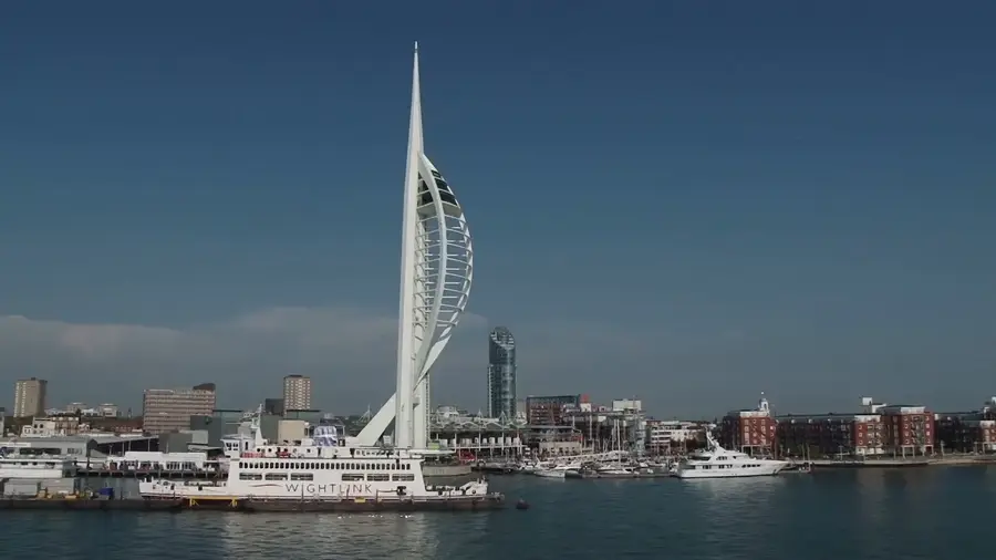 Spinnaker Tower and the waterfront under a dark blue sky